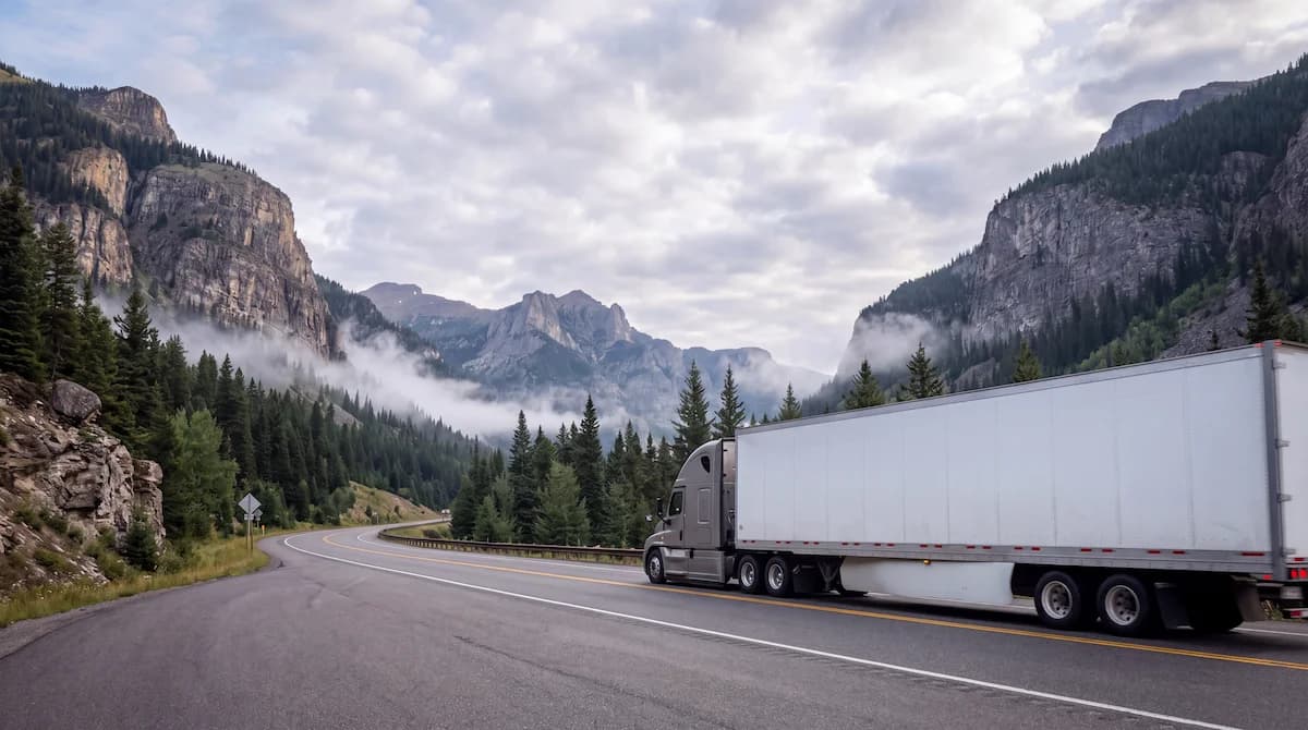 American semi truck on a US highway through the mountains
